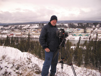 Richard Stringer csc sets up his camera on a hill overlooking Whitehorse last October.